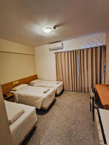 Postel nebo postele na pokoji v ubytování GRAN Parana SUITES HOTEL Asunción Centro