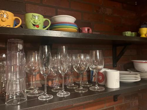 a row of wine glasses sitting on a shelf at Eyja Mork - Aurora Igloo with shared Hot Tub, BBQ and kitchen - B2 in Stora Mork