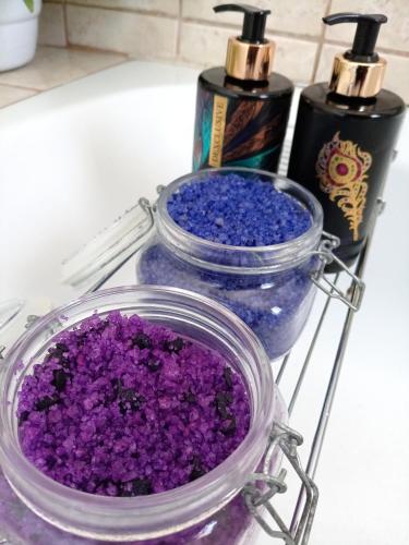 two bottles of purple glitter sitting on a counter at Olivia Pines Guesthouse 4 Bedroom Self Catering House in Krugersdorp