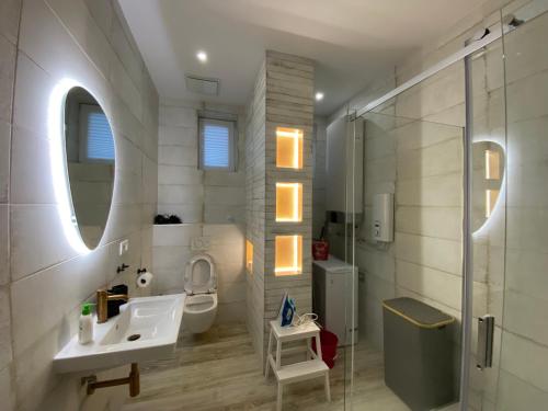 a bathroom with a sink and a toilet and a shower at Art Design Gallery - Bratislava city center in Bratislava