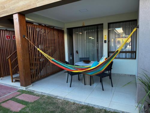 a hammock on the porch of a house at Bioflora Itacimirim Novo village 44 in Camacari