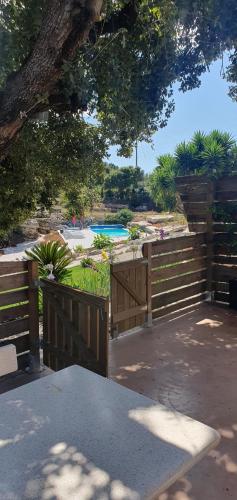 a wooden fence with a pool in the background at Casa Llogan 4P Quinta das Pedras da Lagoa in Alcobaça