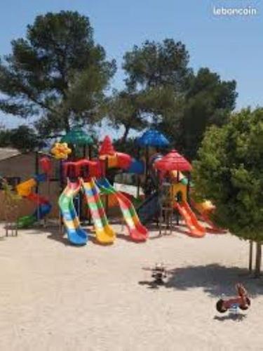 a playground in the sand on a beach at Mobilhome neuf à Camping Domaine l'Ile d'Or à Saint Raphaël in Saint-Raphaël