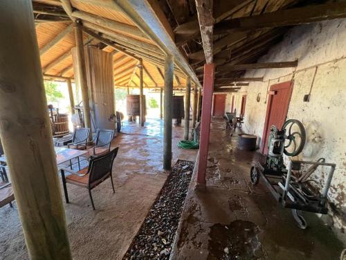 an empty room with chairs and a table in a building at Casa Bagual in Calivoro