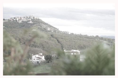 a view of a hill with houses on it at La casa di Belle in Castelchiodato