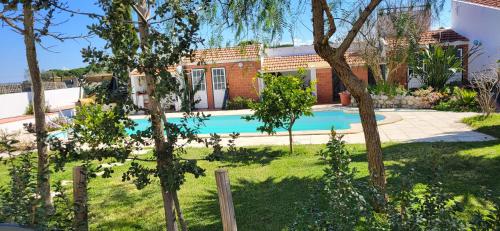 a house with a swimming pool in a yard at MIX inn in Vendas Novas