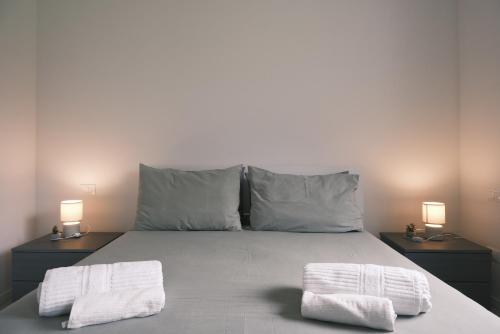 a bedroom with a bed with two towels on it at La Rocca - terrazza panoramica in Darfo