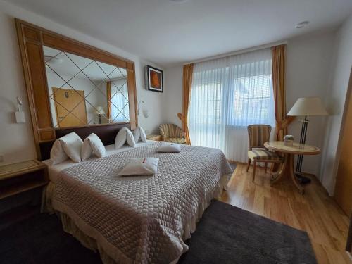 a bedroom with a large bed with a large window at Villa Katharina in Rust