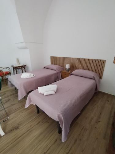 a room with three beds with towels on them at La dimora salentina in Galatone