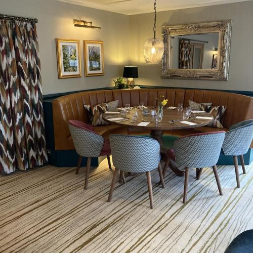 a dining room with a table and chairs at The Britannia Inn & Waves Restaurant in St Austell