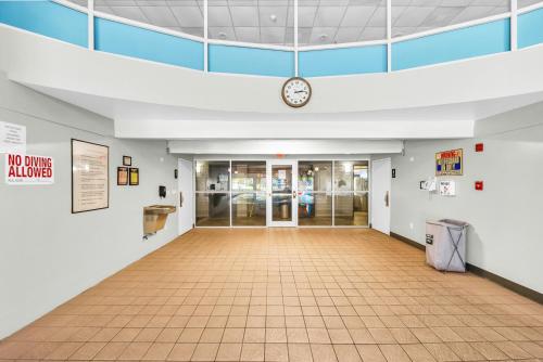 a hallway of a building with a clock on the ceiling at Eastlake Suites Hotel & Conference Center By OYO Urbana in Champaign