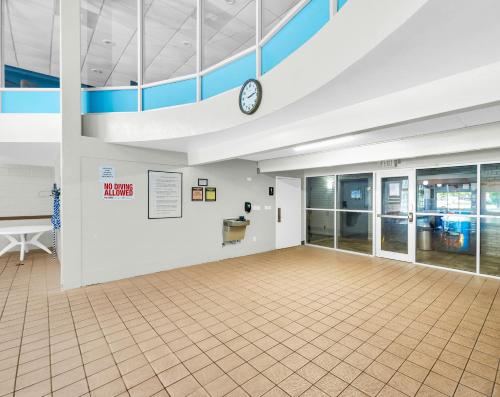 a large room with a clock on the wall at Eastlake Suites Hotel & Conference Center By OYO Urbana in Champaign