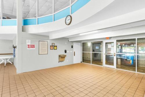 an empty room with a clock on a wall at Eastlake Suites Hotel & Conference Center By OYO Urbana in Champaign