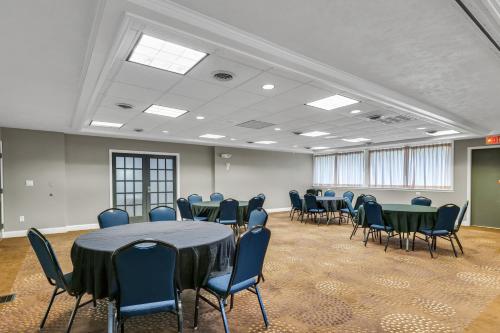 a conference room with tables and chairs in it at Eastlake Suites Hotel & Conference Center By OYO Urbana in Champaign