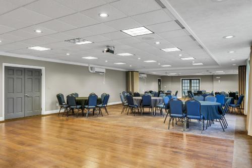 a conference room with blue chairs and tables in it at Eastlake Suites Hotel & Conference Center By OYO Urbana in Champaign
