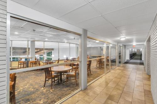 a large room with tables and chairs and windows at Eastlake Suites Hotel & Conference Center By OYO Urbana in Champaign