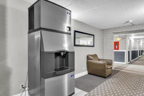 a large stainless steel oven in a room with a chair at Eastlake Suites Hotel & Conference Center By OYO Urbana in Champaign