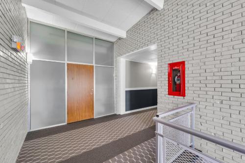 a hallway with a red box on a brick wall at Eastlake Suites Hotel & Conference Center By OYO Urbana in Champaign