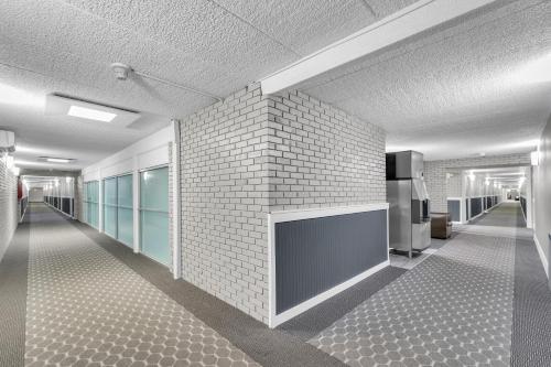 a room with a brick wall and a fireplace at Eastlake Suites Hotel & Conference Center By OYO Urbana in Champaign