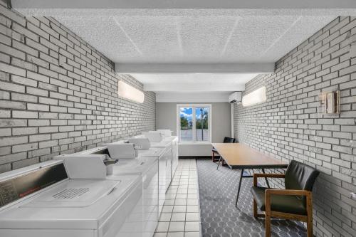 a waiting room with a row of tables and chairs at Eastlake Suites Hotel & Conference Center By OYO Urbana in Champaign