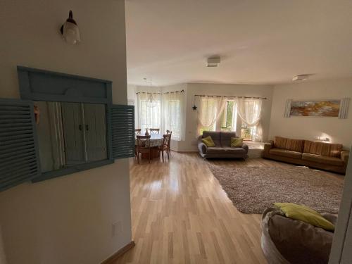 a living room with a couch and a table at Gross Nofesh and Spa Guesthouse in Bet Hillel
