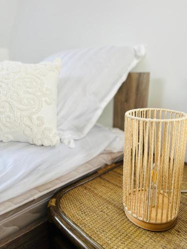 a table with a bed with a lamp on it at Dom na wzgórzu z widokiem na jezioro in Brodnica Dolna