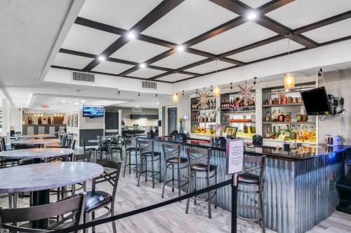 a restaurant with tables and chairs and a bar at Eastlake Suites Hotel & Conference Center By OYO Urbana in Champaign