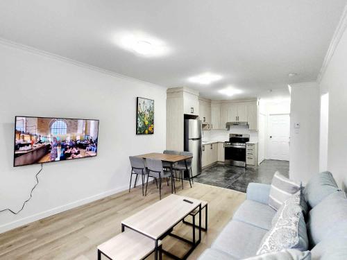 a living room with a couch and a table at APARTMENT HOTEL ST-DENIS in Montréal