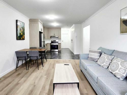 a living room with a couch and a table at APARTMENT HOTEL ST-DENIS in Montréal