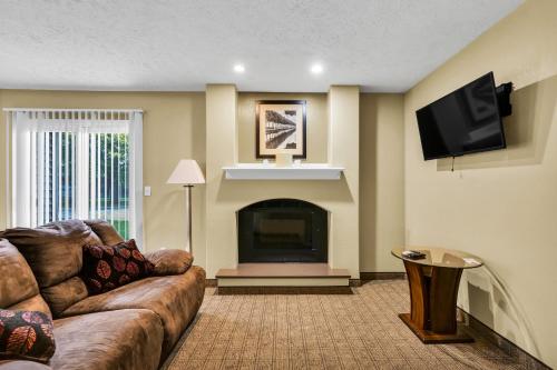 a living room with a couch and a fireplace at Eastlake Suites Hotel & Conference Center By OYO Urbana in Champaign