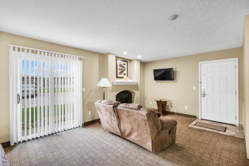 a living room with a couch and a door at Eastlake Suites Hotel & Conference Center By OYO Urbana in Champaign