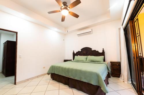 a bedroom with a bed and a ceiling fan at Villa Tropical By Vacation Pura Vida in Esterillos Este