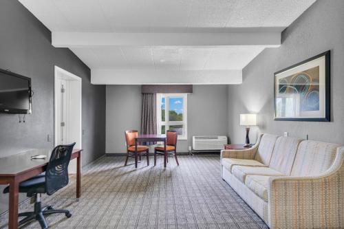 a living room with a couch and a table at Eastlake Suites Hotel & Conference Center By OYO Urbana in Champaign