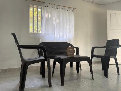 a table and two chairs and a table and a stool at Cabaña MARDELA Casa de Playa in San Antero