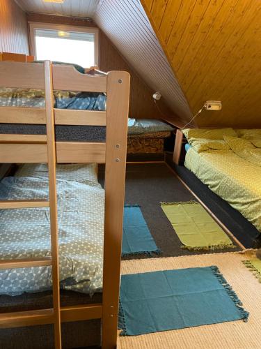 two bunk beds in a room with a attic at Kokava Línia chata 2 in Kokava na Rimavica