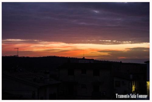 a sunset in the sky over a city at La casa di Belle in Castelchiodato