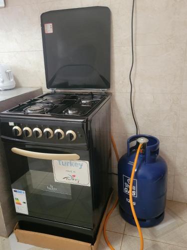 a stove with a tv on top of it at Biira Transit Residence Entebbe with free airport pickup in Entebbe