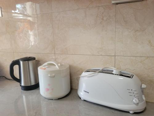 a toaster and a toaster on a kitchen counter at Biira Transit Residence Entebbe with free airport pickup in Entebbe