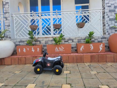 a small toy car parked in front of a house at Biira Transit Residence Entebbe with free airport pickup in Entebbe