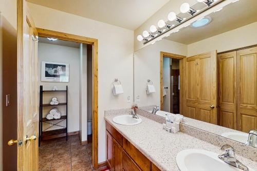 a bathroom with two sinks and a large mirror at Cottonwoods 455 in Moab