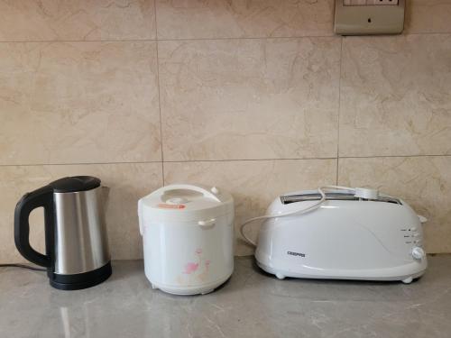 a toaster and a toaster sitting on a counter at Biira Transit Residence Entebbe with free airport pickup in Entebbe