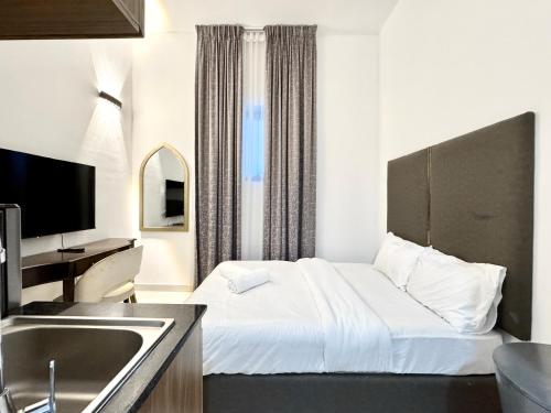 a hotel room with a bed and a sink at Al Manara Classic Cozy Studio in Dubai