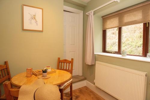 a dining room with a table and a window at Walker's Rest in Newland