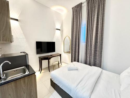 a hotel room with a bed and a desk at Al Manara Classic Cozy Studio in Dubai