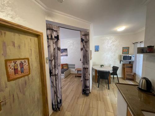 a kitchen and a living room with a table at Gross Nofesh and Spa Guesthouse in Bet Hillel