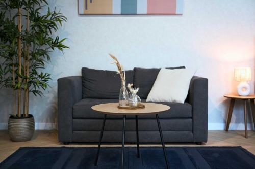 a living room with a couch and a table at Central City Escape Modern Studio Near Everything in Eindhoven