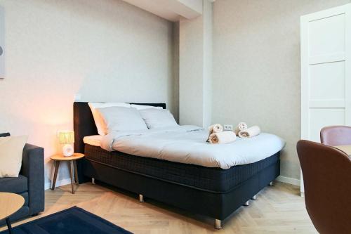 a bedroom with a bed with two stuffed animals on it at Central City Escape Modern Studio Near Everything in Eindhoven