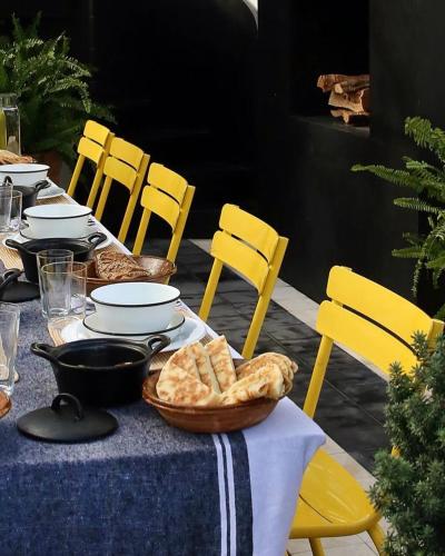 a table with yellow chairs and a table with bread at Villa Augustine in Tangier