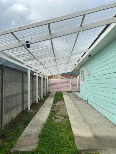 an empty building with awning over a walkway at Hostal Chucaita Puerto Cisnes in Puerto Cisnes
