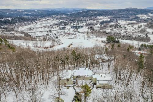an aerial view of a house in the snow at Steps to Ski Trail Fireplace - Kingswood 1B in Quechee